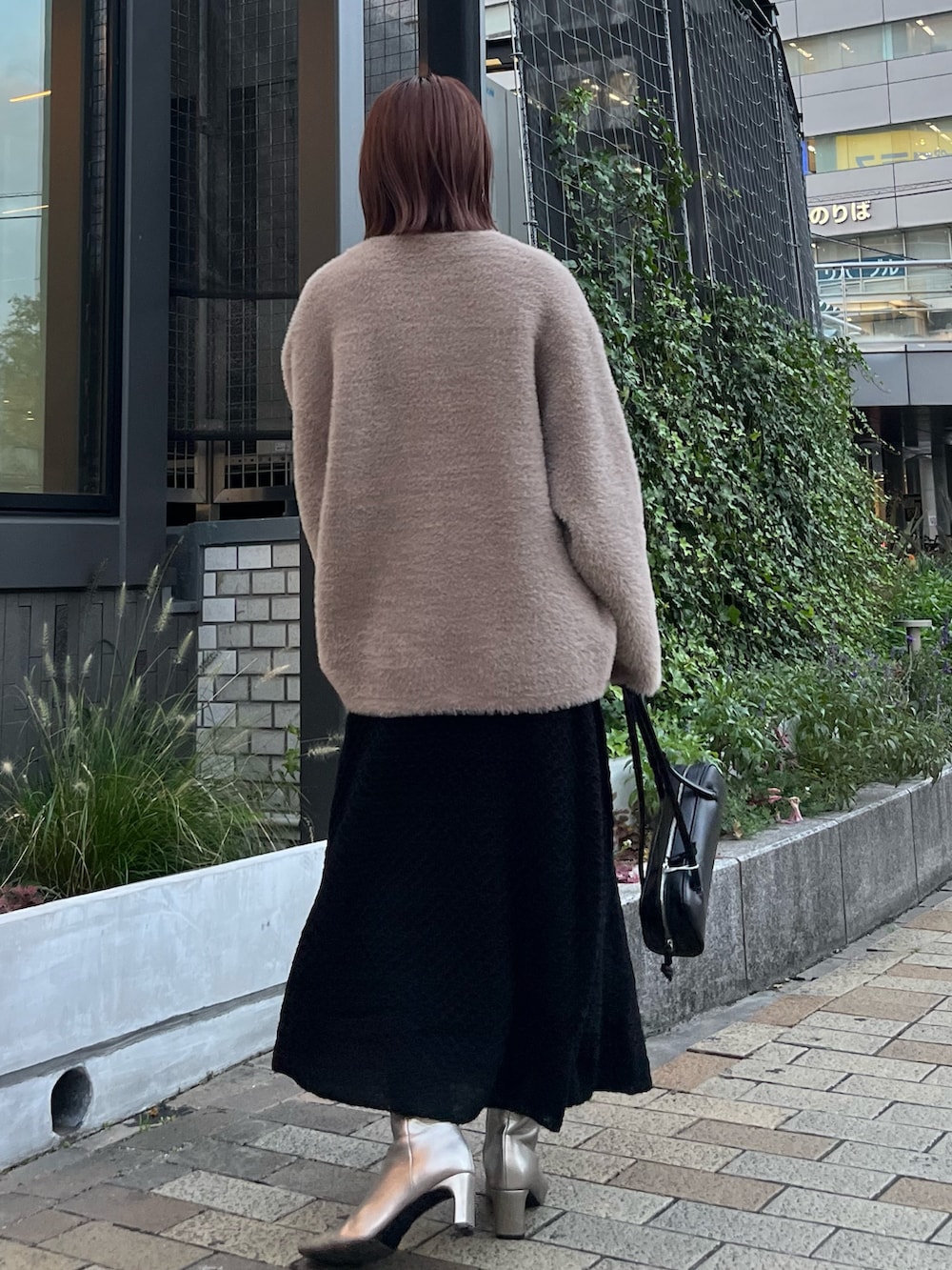 ブラック系のワンピース、シルバー系のブーツ、ブラック系のショルダーバッグを着用したレディースの秋コーディネートの3枚目の写真