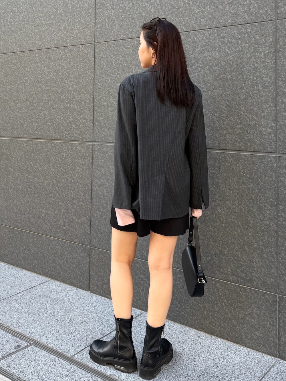 ブラック系のその他パンツ、ピンク系のTシャツ/カットソー、グレー系のテーラードジャケットを着用したレディースの冬コーディネートの3枚目の写真