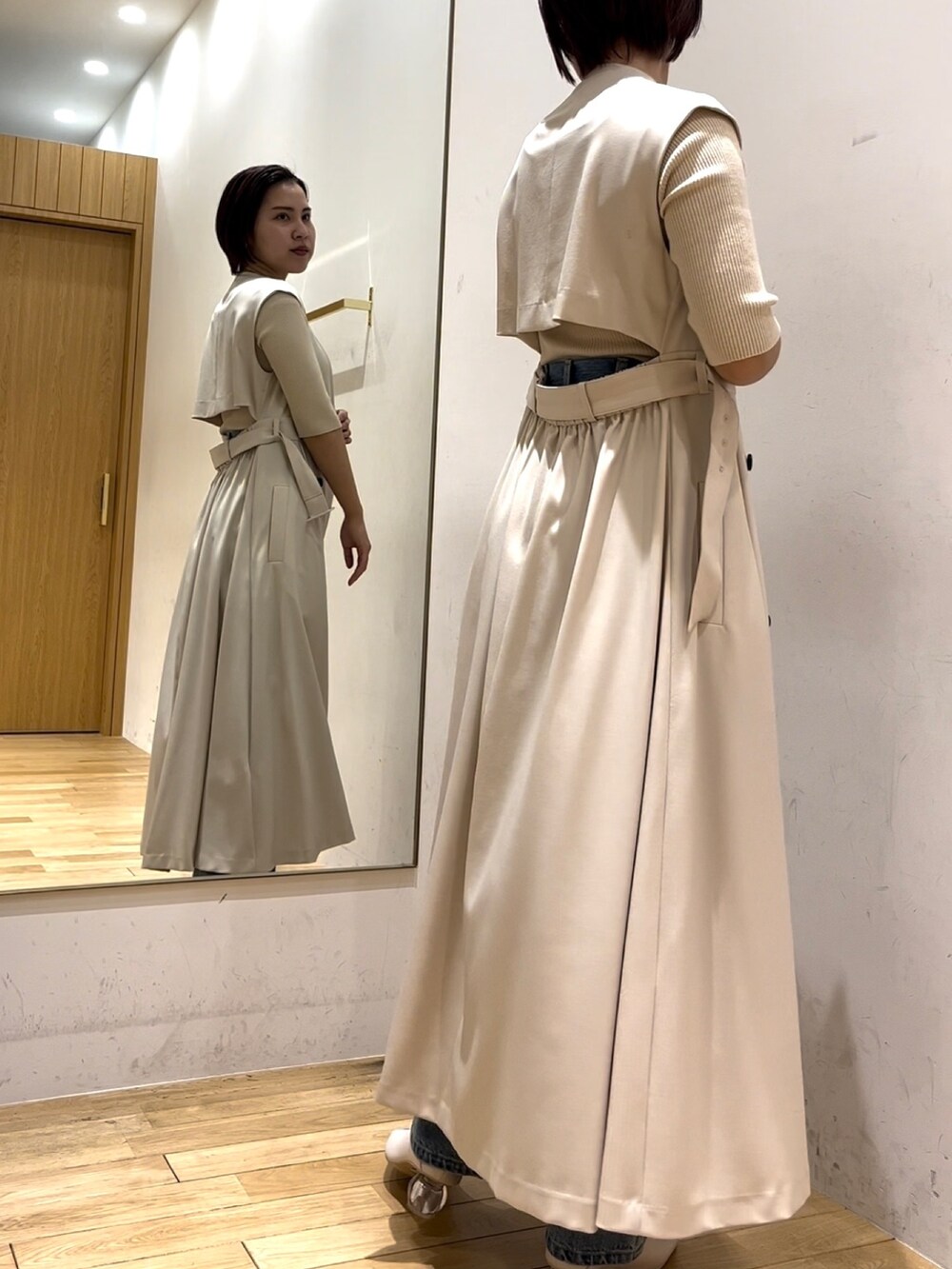 ホワイト系のニット/セーター、ブルー系のデニムパンツ、ホワイト系のパンプスを着用したレディースの冬コーディネートの2枚目の写真