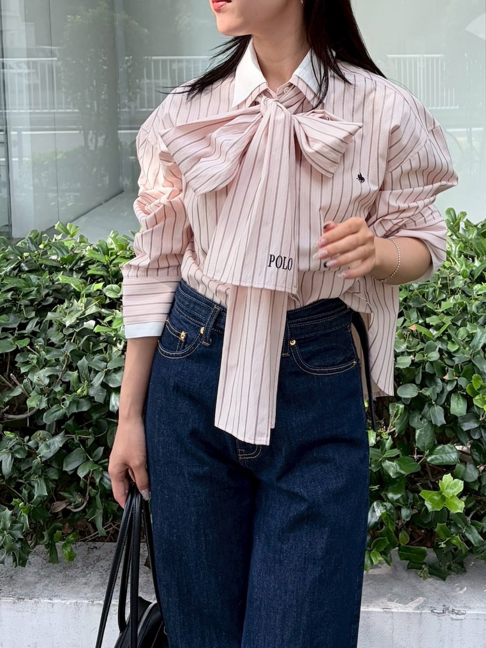 ブルー系のデニムパンツ、ブラック系のブーツ、ピンク系のシャツ/ブラウスを着用したレディースの夏コーディネートの5枚目の写真