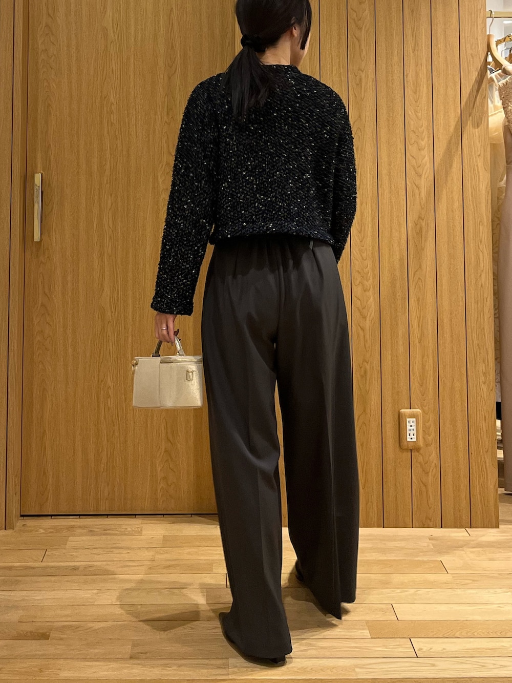 グレー系のその他パンツ、ブルー系のカーディガン/ボレロ、ゴールド系のハンドバッグを着用したレディースの冬コーディネートの3枚目の写真