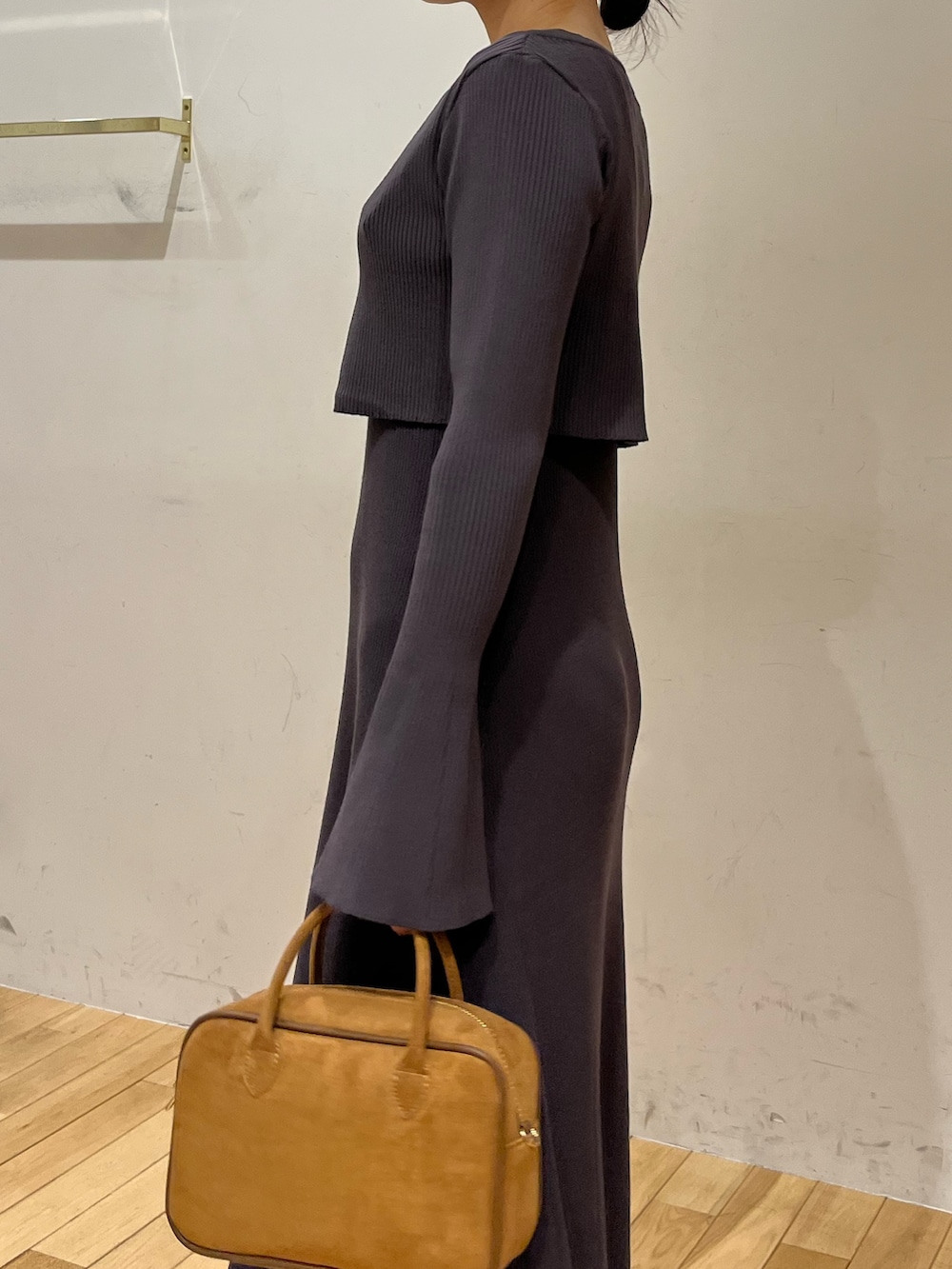 ブラック系のブーツ、グレー系のワンピース、ブラウン系のハンドバッグを着用したレディースの秋コーディネートの6枚目の写真