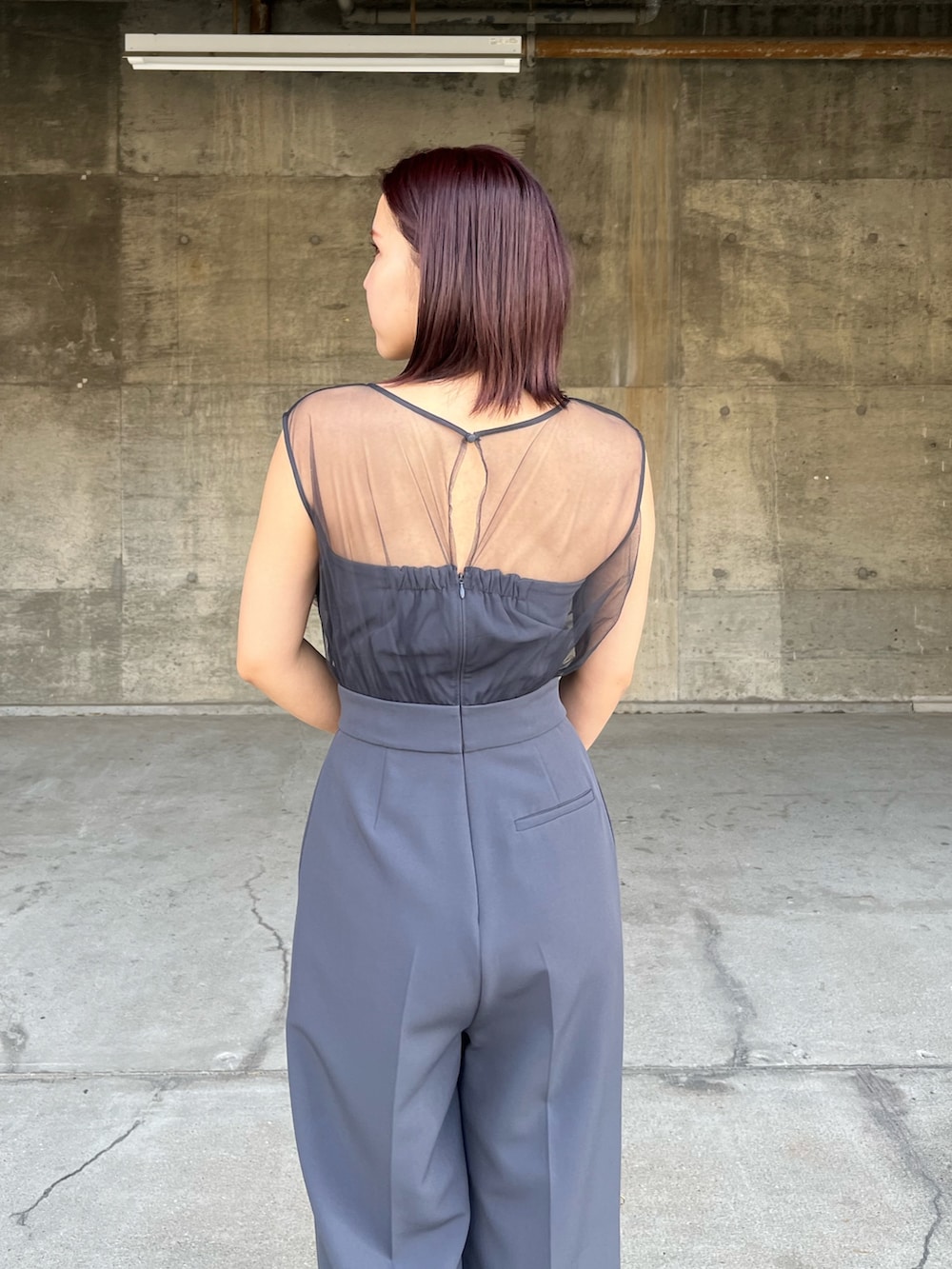 グレー系のパンツドレス、その他のクラッチバッグ、その他のパンプスを着用したレディースの冬コーディネートの6枚目の写真