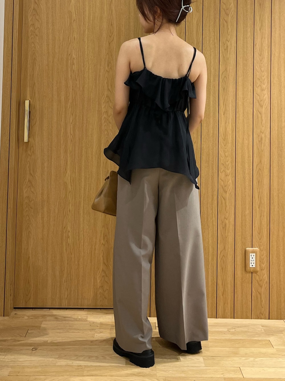 ブラウン系のハンドバッグ、ブラック系のキャミソール、ブラウン系のその他パンツを着用したレディースの夏コーディネートの3枚目の写真