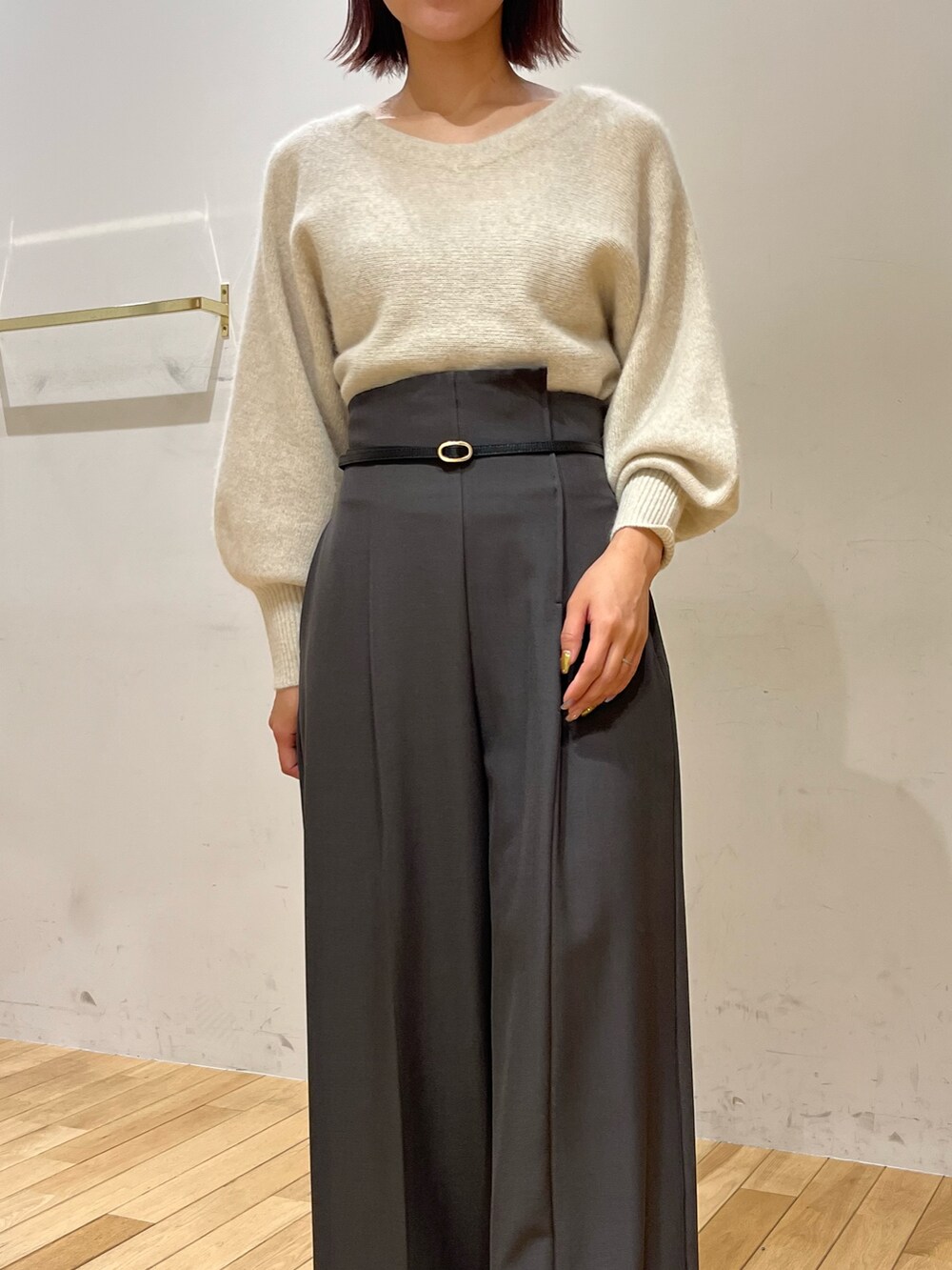 グレー系のその他パンツ、ホワイト系のニット/セーター、シルバー系のブーツを着用したレディースの秋コーディネートの4枚目の写真