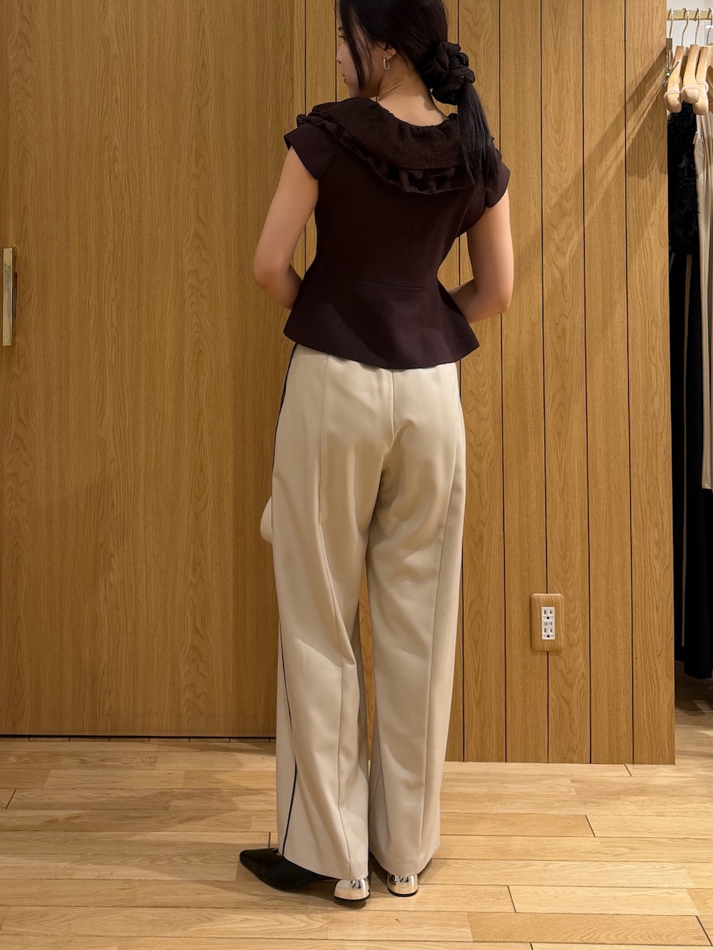 ブラック系のパンプス、ホワイト系のハンドバッグ、ベージュ系のその他パンツを着用したレディースの春コーディネートの3枚目の写真