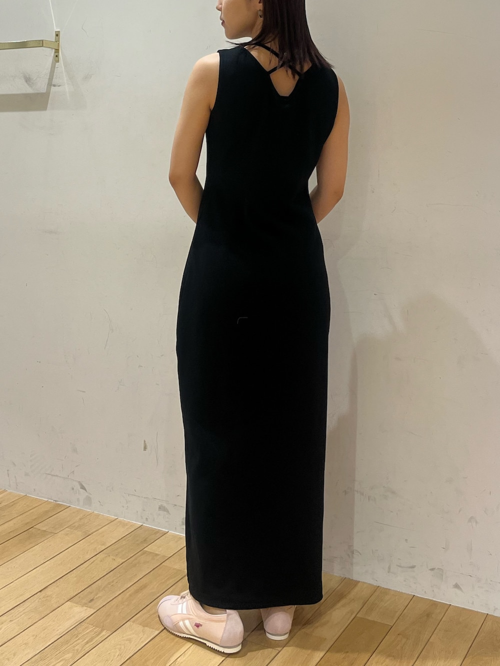 ブラック系のワンピース、ピンク系のスニーカー、ブラウン系のハンドバッグを着用したレディースの夏コーディネートの3枚目の写真