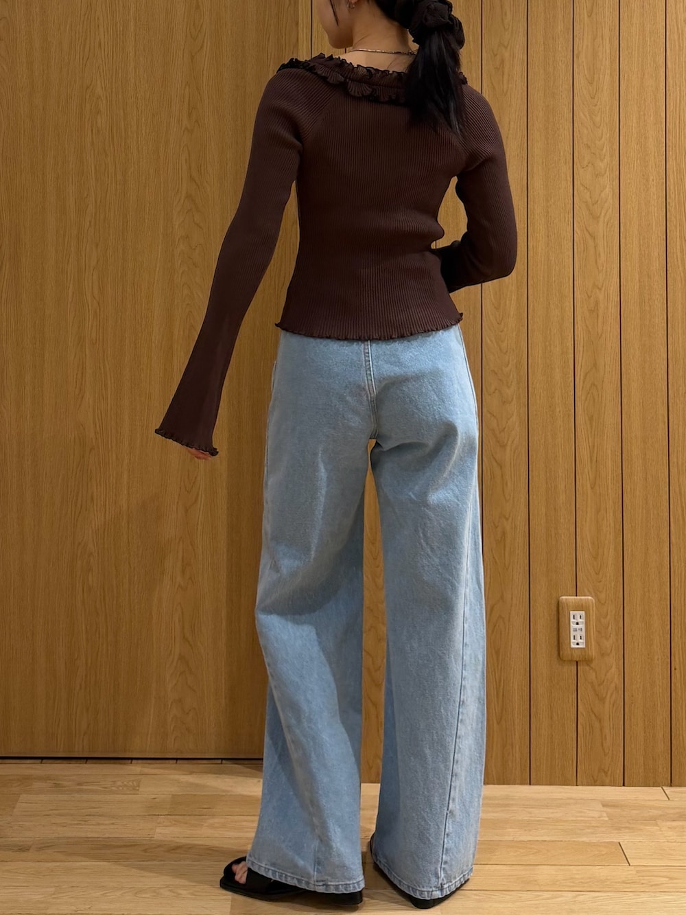 ブラウン系のニット/セーター、ブルー系のデニムパンツ、ブラック系のサンダルを着用したレディースの春コーディネートの3枚目の写真