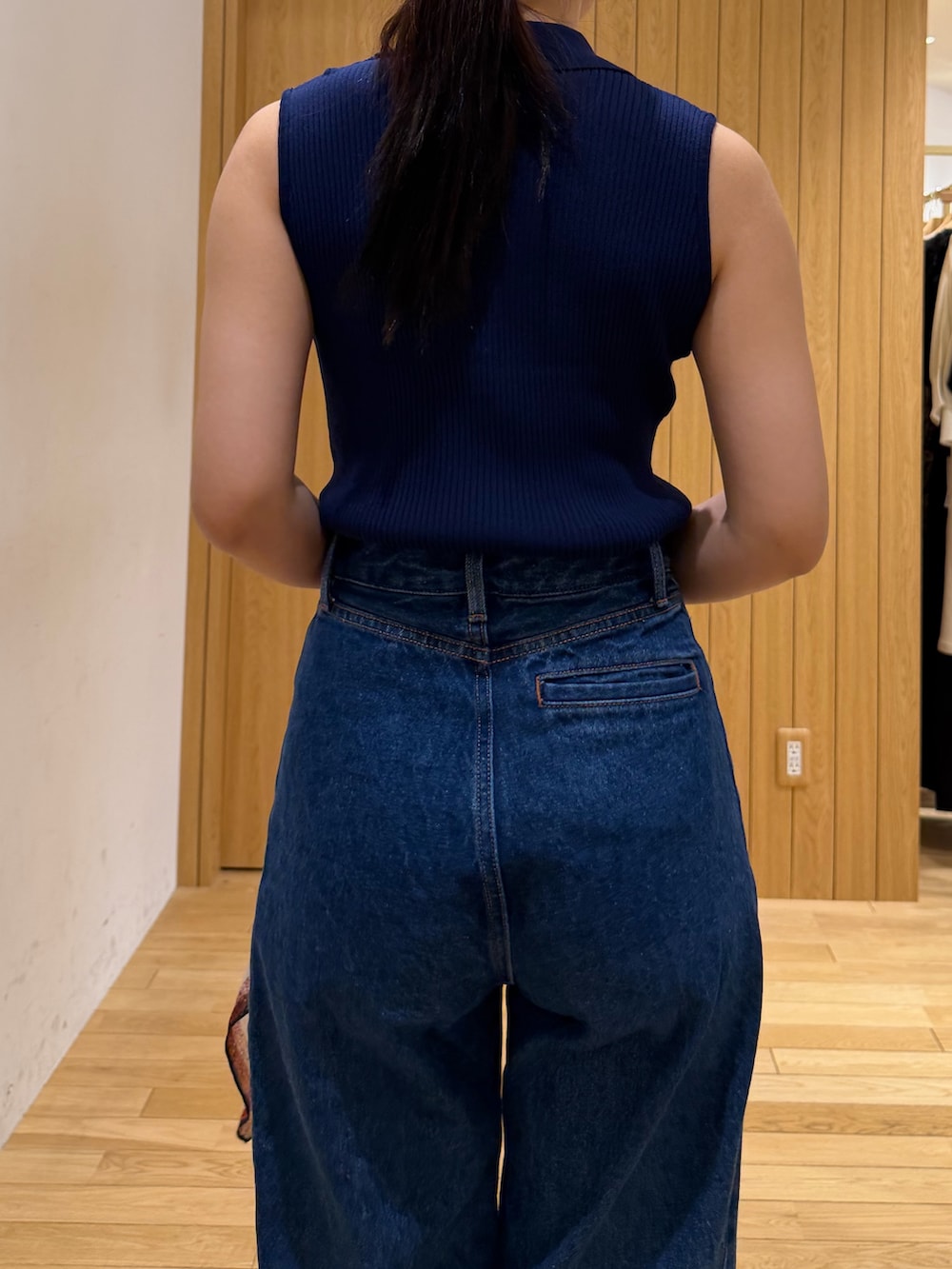 ブルー系のデニムパンツ、ブルー系のニット/セーター、ブラウン系のサンダルを着用したレディースの夏コーディネートの6枚目の写真