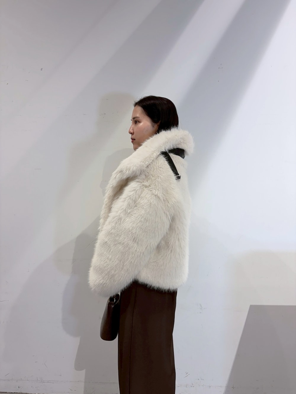 ブラウン系のその他パンツ、レッド系のニット/セーター、ホワイト系のその他アウターを着用したレディースの夏コーディネートの5枚目の写真