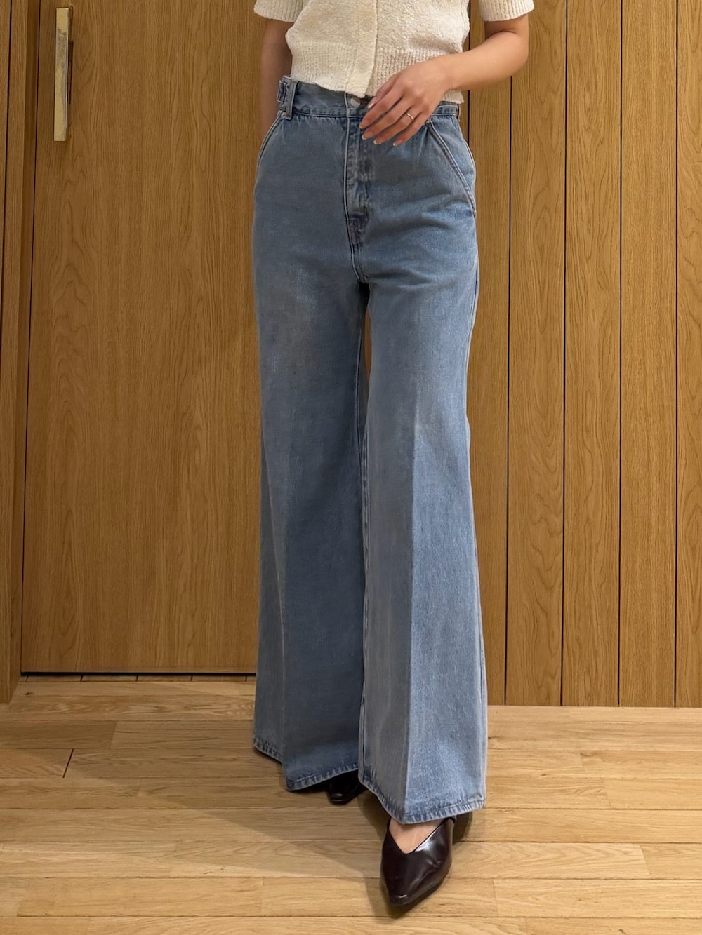 ホワイト系のニット/セーター、ブラウン系のテーラードジャケット、ブルー系のデニムパンツを着用したレディースの春コーディネートの8枚目の写真