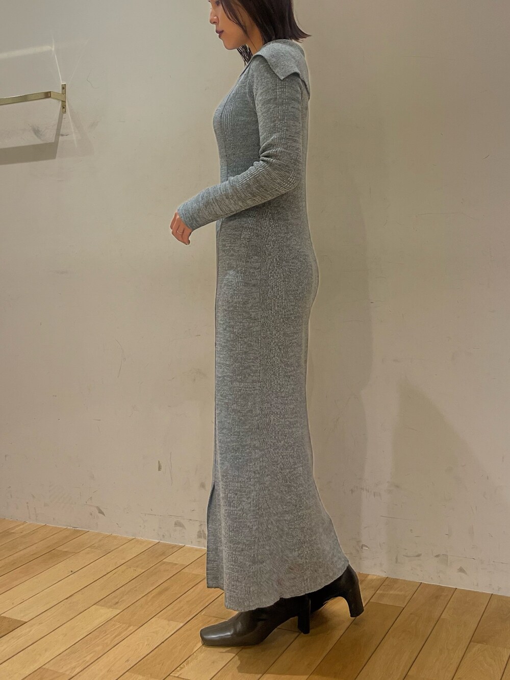 ブルー系のワンピース、ブラック系のブーツを着用したレディースの冬コーディネートの2枚目の写真