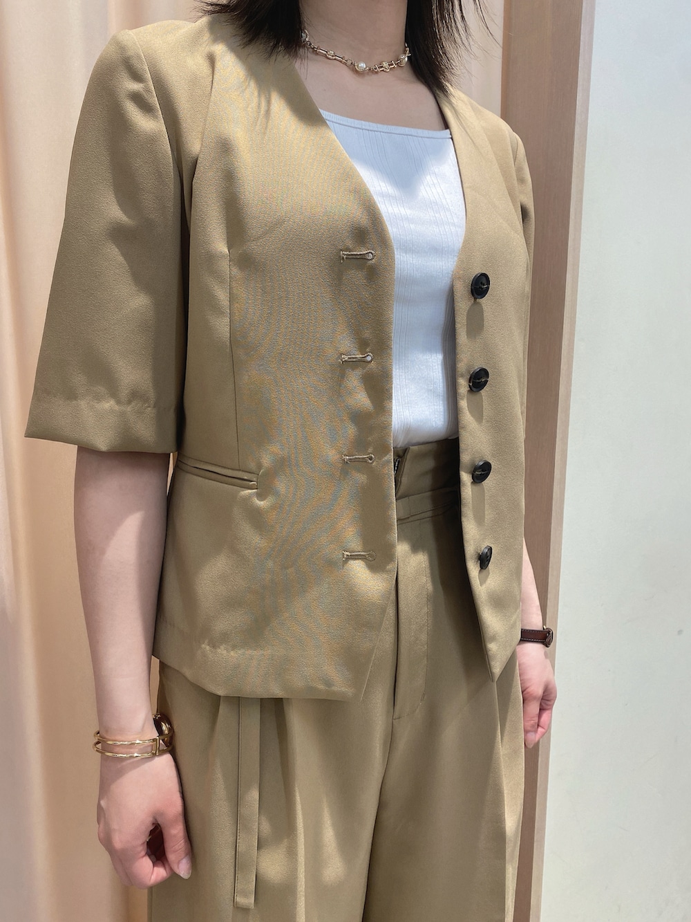 ベージュ系のノーカラージャケット、ベージュ系のその他パンツ、ホワイト系のサンダルを着用したレディースの春コーディネートの3枚目の写真