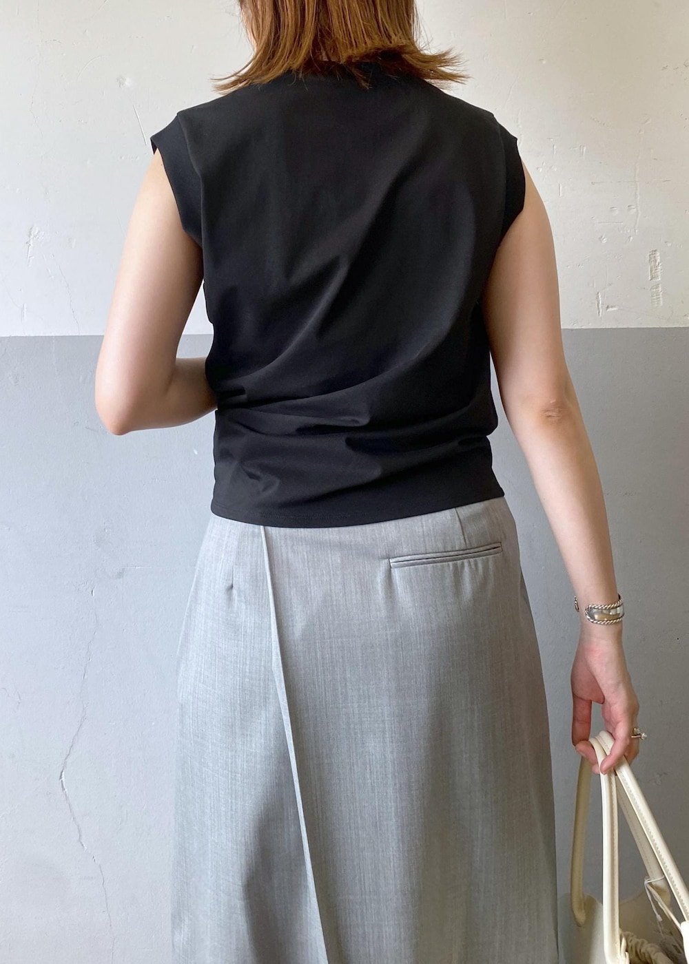 ブラック系のサンダル、グレー系のスカート、ブラック系のタンクトップを着用したレディースの夏コーディネートの10枚目の写真