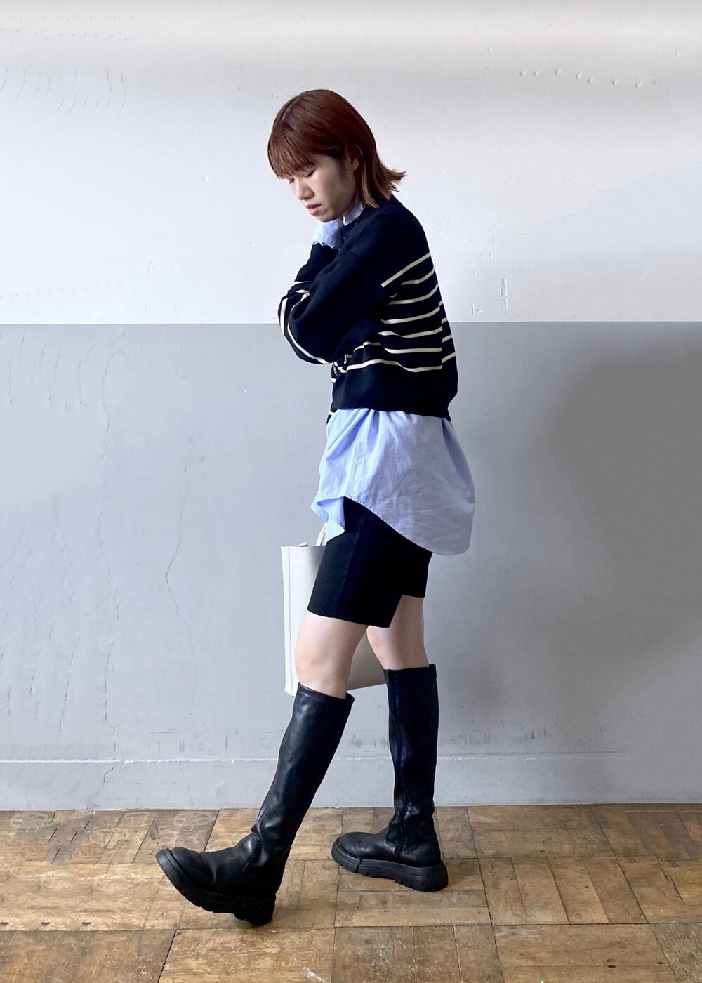 ホワイト系のトートバッグ、ブラック系のニット/セーター、ブルー系のシャツ/ブラウスを着用したレディースの秋コーディネートの4枚目の写真