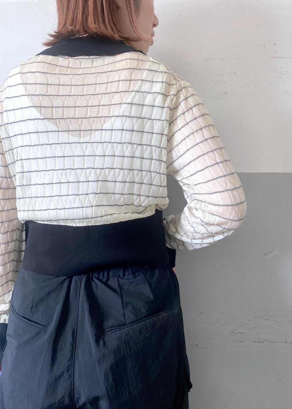 ブラック系のパンプス、パープル系のトートバッグ、ホワイト系のカーディガン/ボレロを着用したレディースの夏コーディネートの9枚目の写真