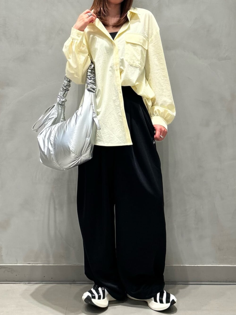 ベージュ系のTシャツ/カットソー、ブラック系のその他パンツ、シルバー系のショルダーバッグを着用したレディースの夏コーディネートの2枚目の写真