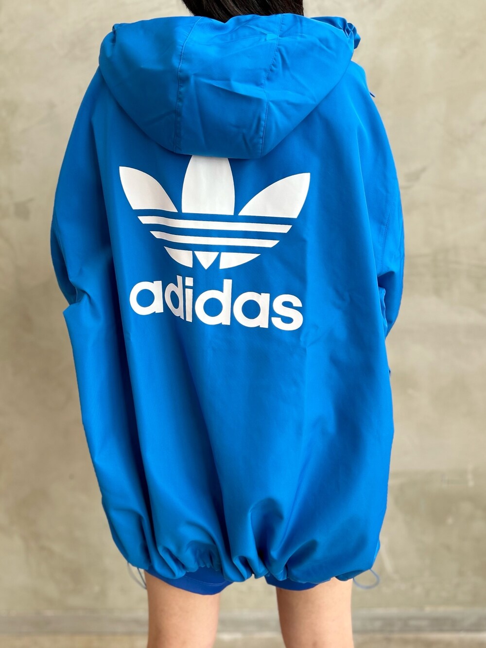 ブルー系のナイロンジャケット、ブルー系のその他パンツ、ホワイト系のスニーカーを着用したレディースの冬コーディネートの6枚目の写真