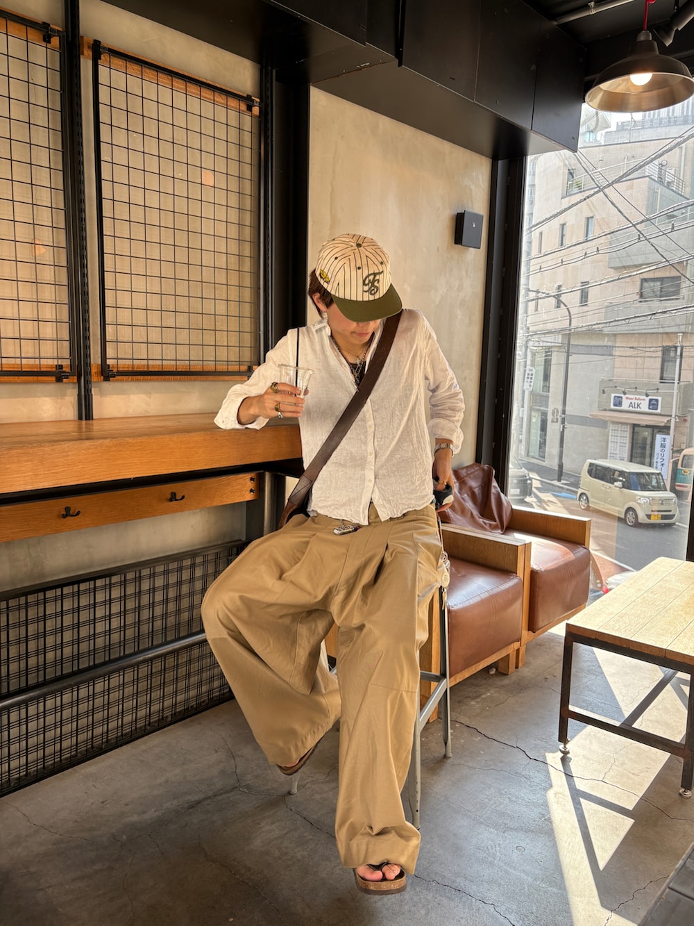 ホワイト系のシャツ/ブラウス、ベージュ系のチノパンツ、ブラウン系のサンダルを着用したメンズの夏コーディネートの2枚目の写真