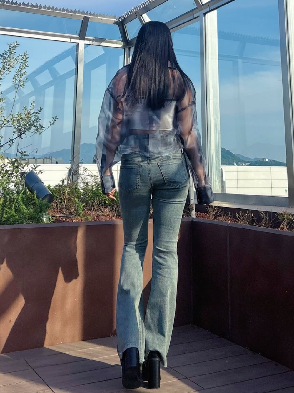 ブラック系のサンダル、ブルー系のシャツ/ブラウス、ホワイト系のTシャツ/カットソーを着用したレディースの春コーディネートの5枚目の写真