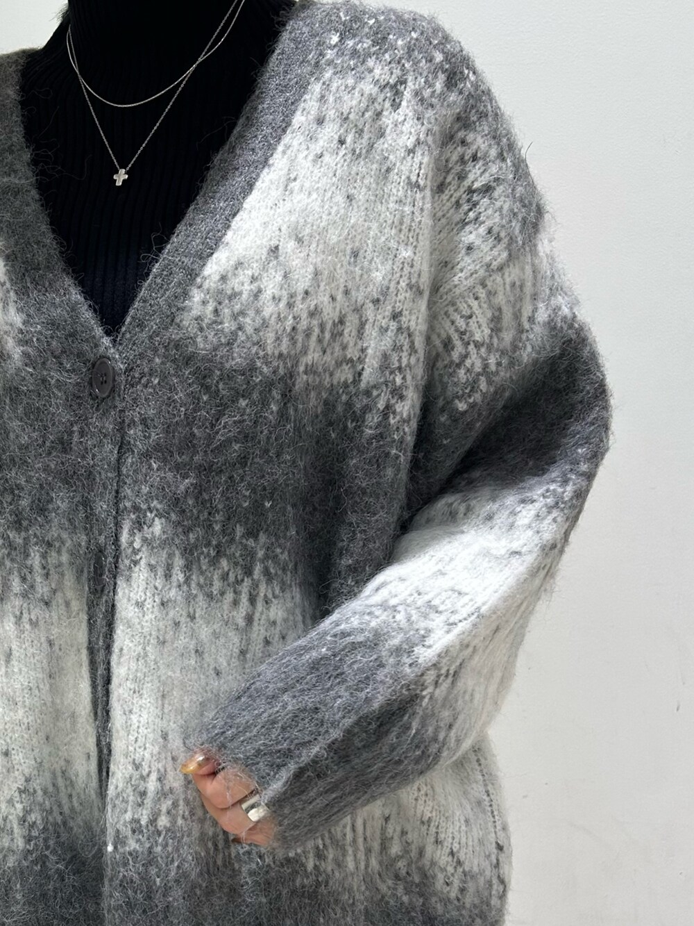 ブラック系のニット/セーター、ブラック系のショルダーバッグ、グレー系のカーディガン/ボレロを着用したレディースの秋コーディネートの8枚目の写真