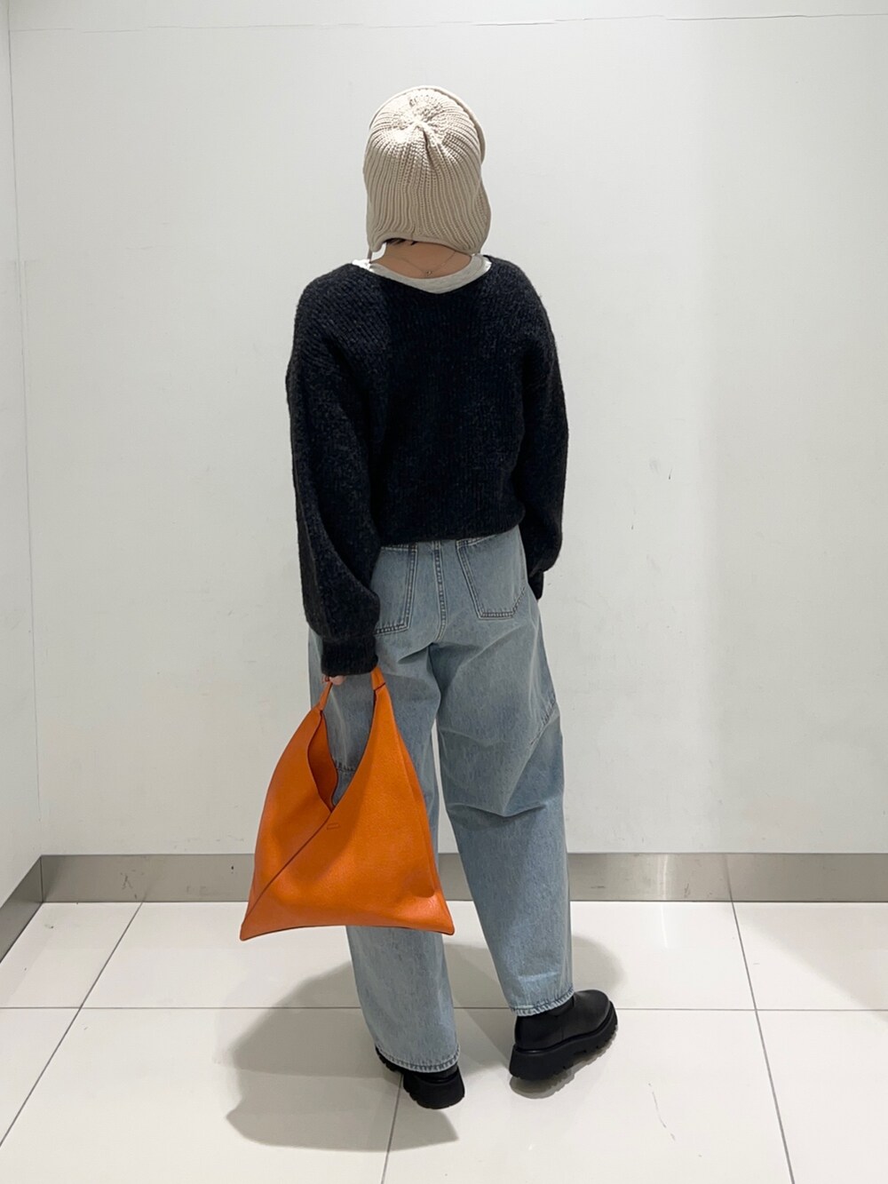 ブルー系のデニムパンツ、その他のTシャツ/カットソー、ブラック系のニット/セーターを着用したレディースの秋コーディネートの4枚目の写真