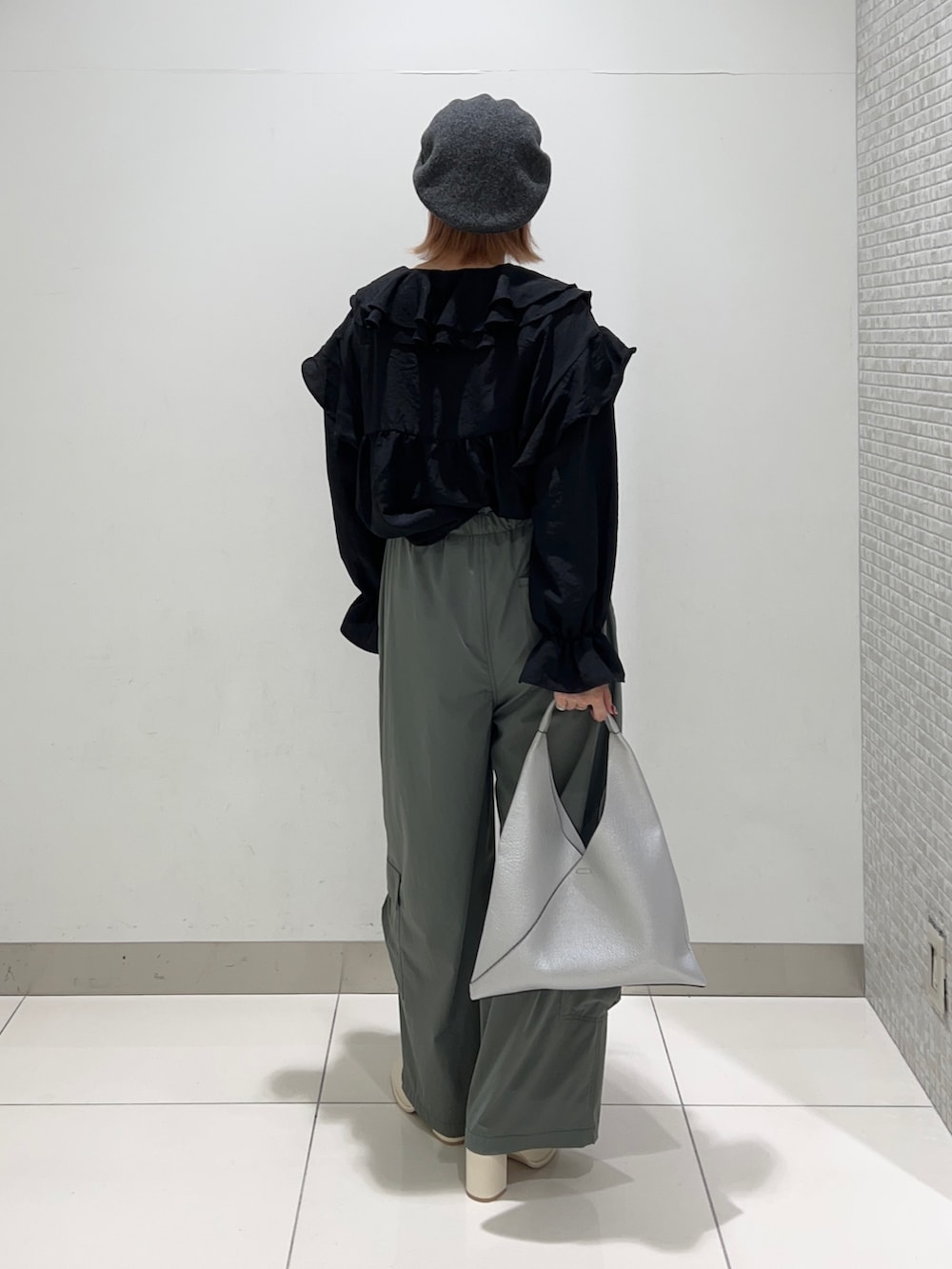 ブラック系のシャツ/ブラウス、グリーン系のサロペット/オーバーオール、ホワイト系のブーツを着用したレディースの秋コーディネートの4枚目の写真