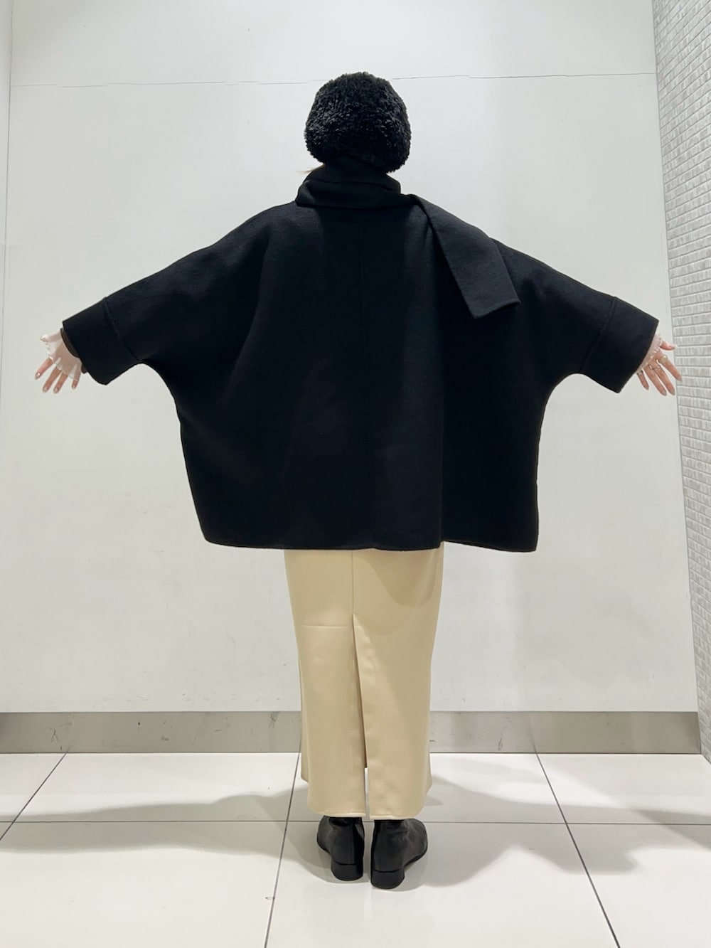 ブラック系のその他アウター、ブラック系のトートバッグ、ベージュ系のワンピースを着用したレディースの冬コーディネートの7枚目の写真