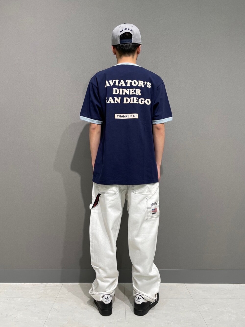 ブルー系のTシャツ/カットソー、ホワイト系のデニムパンツ、グレー系のキャップを着用したメンズの春コーディネートの2枚目の写真
