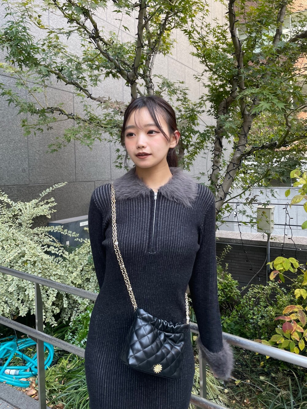 ブラック系のワンピース、ブラック系のショルダーバッグ、その他のブーツを着用したレディースの秋コーディネートの4枚目の写真