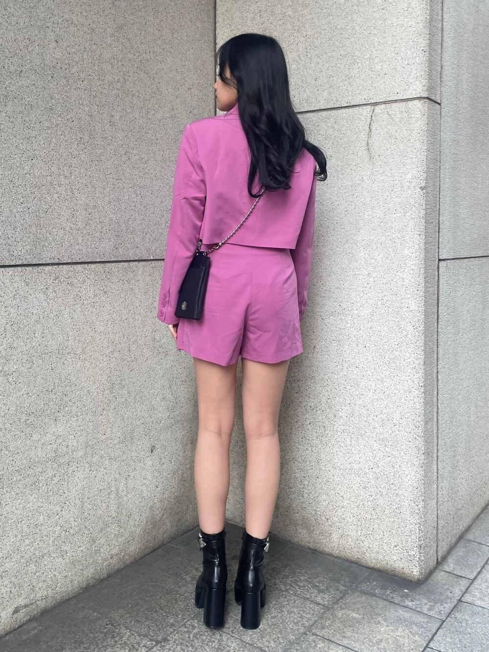 ピンク系のテーラードジャケット、ブラック系のキャミソール、ピンク系のその他パンツを着用したレディースの春コーディネートの2枚目の写真