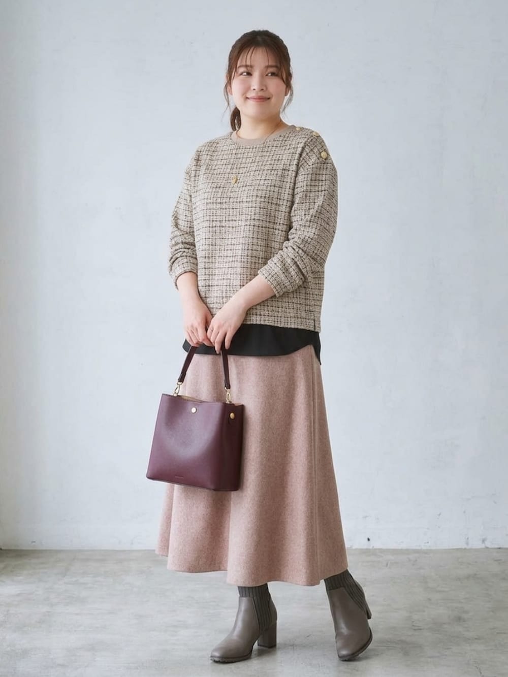 ベージュ系のTシャツ/カットソー、ベージュ系のスカート、レッド系のショルダーバッグを着用したレディースの秋コーディネートの2枚目の写真