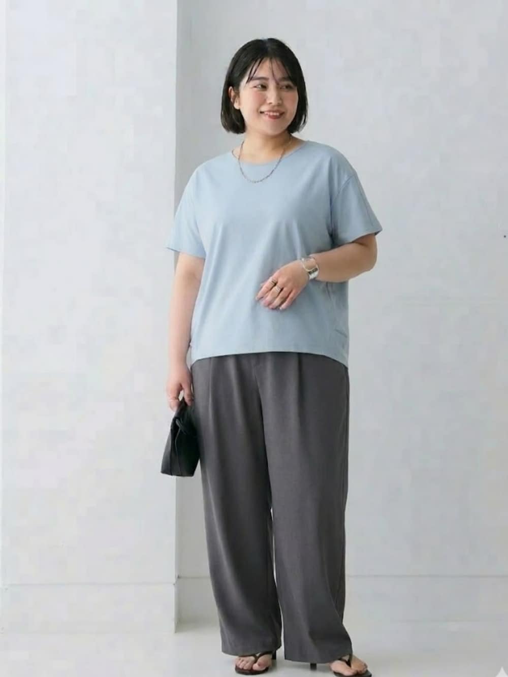 グレー系のパンツ、ブルー系のTシャツ/カットソーを着用したレディースの春コーディネートの2枚目の写真