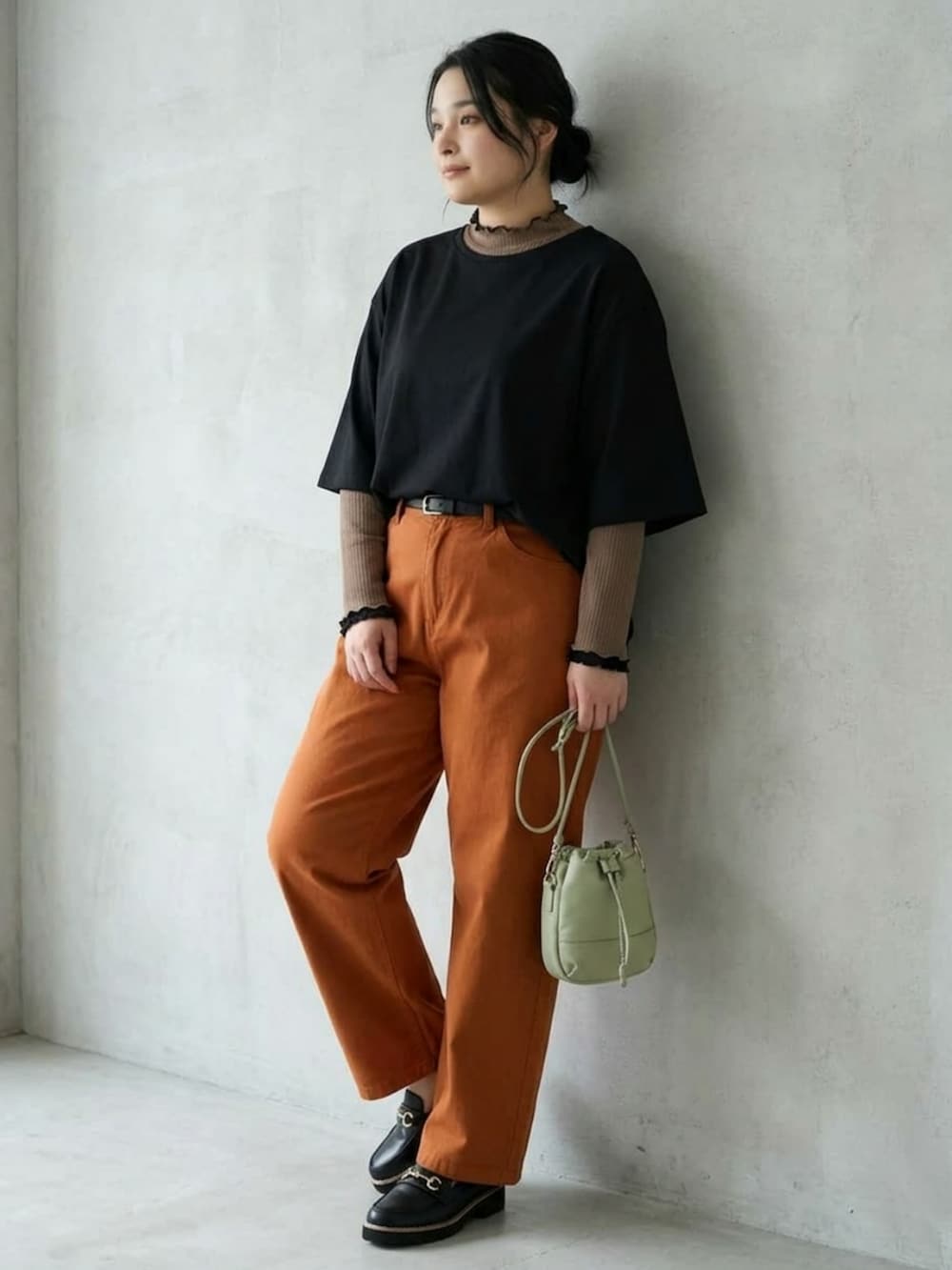 ブラウン系のTシャツ/カットソー、ブラック系のローファー、グレー系のショルダーバッグを着用したレディースの秋コーディネートの2枚目の写真