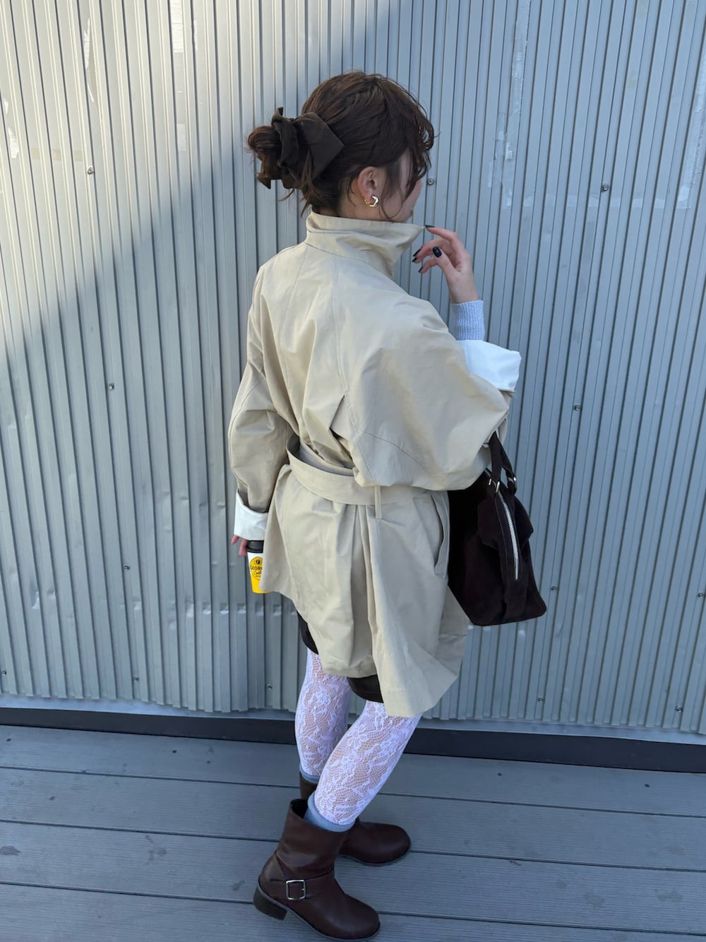 ベージュ系のその他アウター、ブラウン系のブーツ、ブラウン系のボストンバッグを着用したレディースの冬コーディネートの5枚目の写真