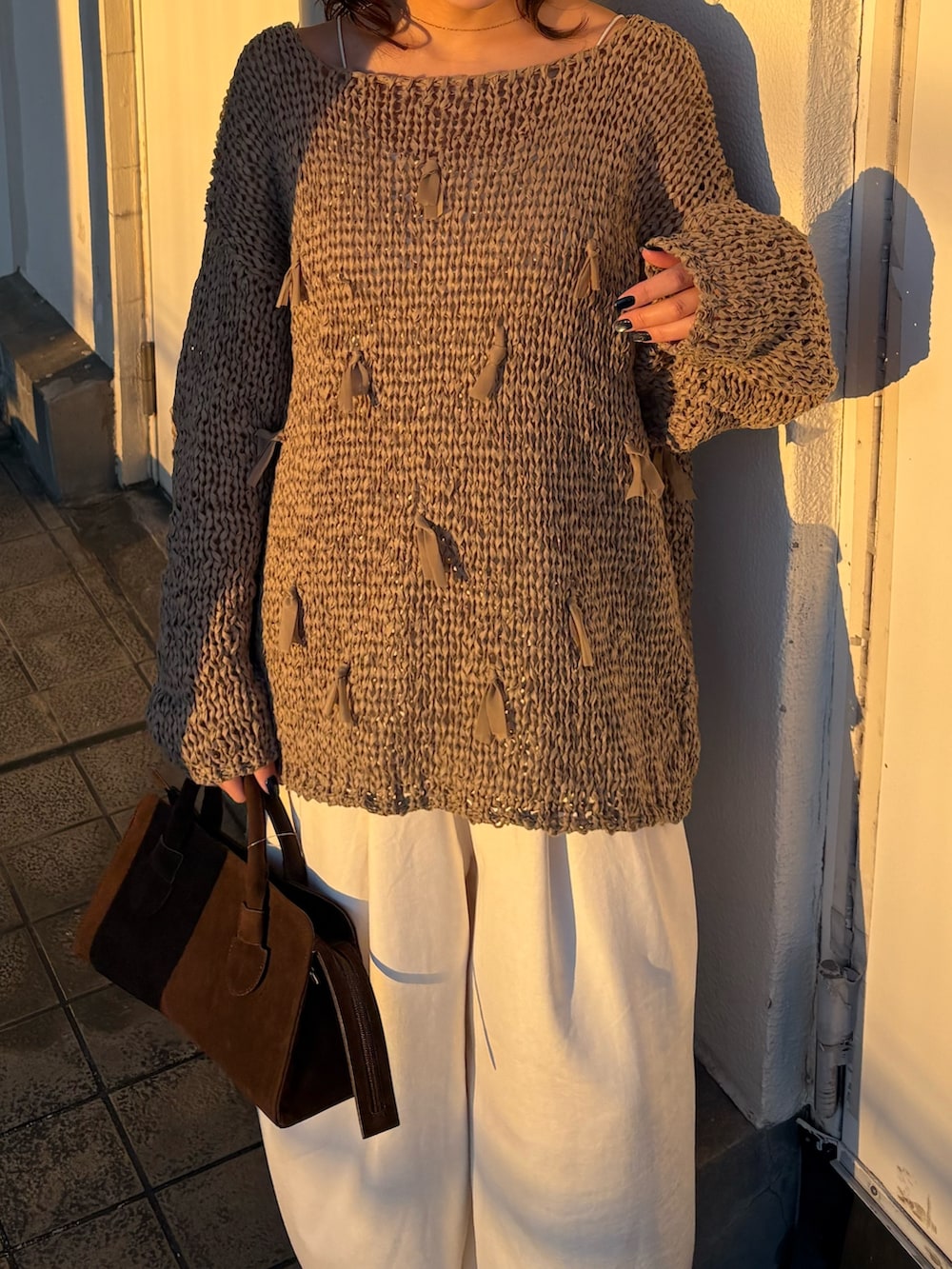 グリーン系のニット/セーター、ホワイト系のその他パンツ、ブラック系のパンプスを着用したレディースの冬コーディネートの4枚目の写真