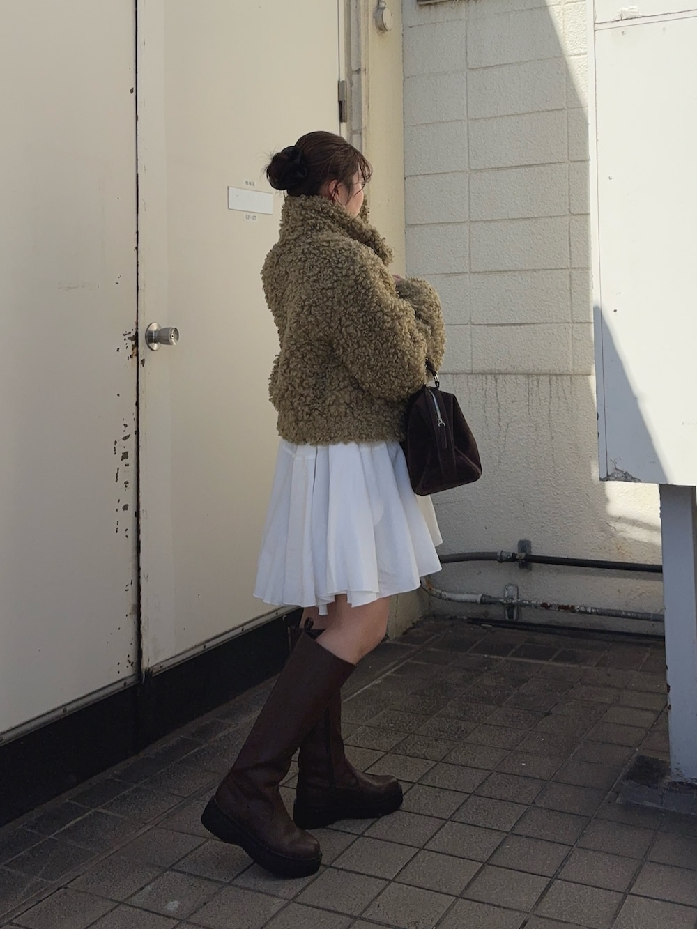 グリーン系のその他アウター、ホワイト系のワンピース、ブラック系のブーツを着用したレディースの冬コーディネートの2枚目の写真