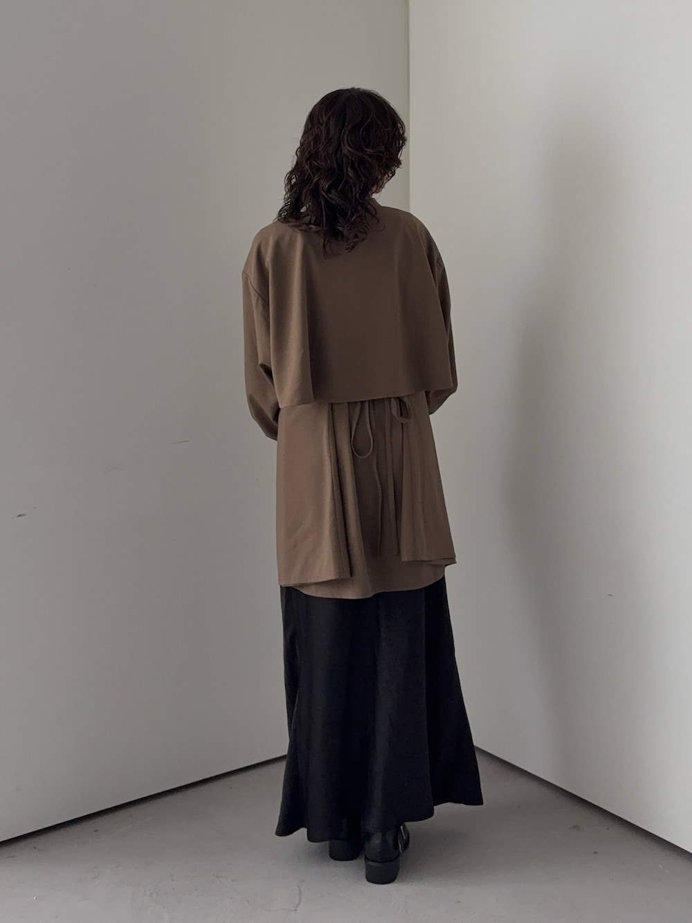 ブラウン系のワンピース、グレー系のスカートを着用したレディースの秋コーディネートの3枚目の写真