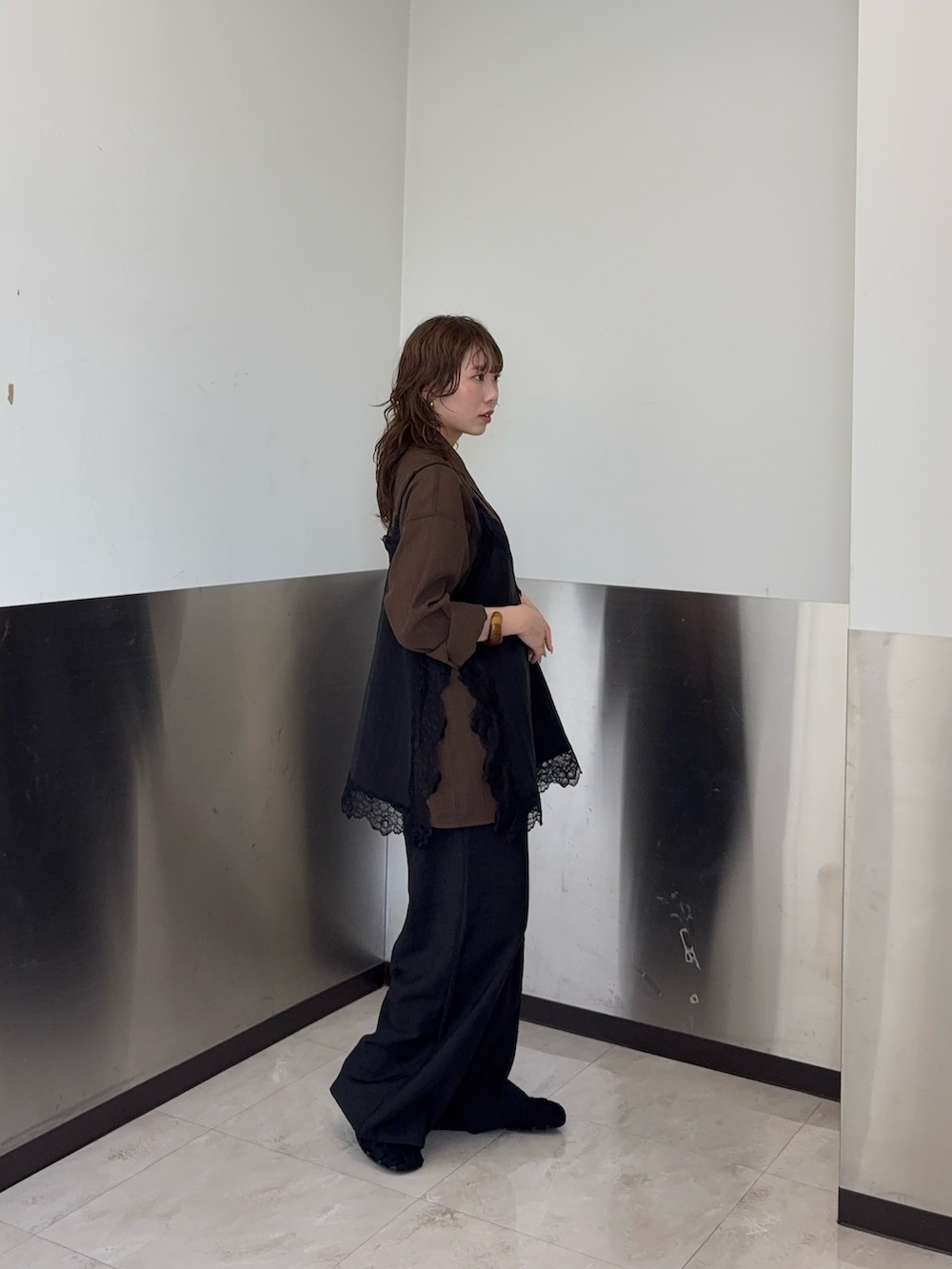 ブラック系のキャミソール、ブラック系のその他パンツ、ブラウン系のその他アウターを着用したレディースの春コーディネートの2枚目の写真