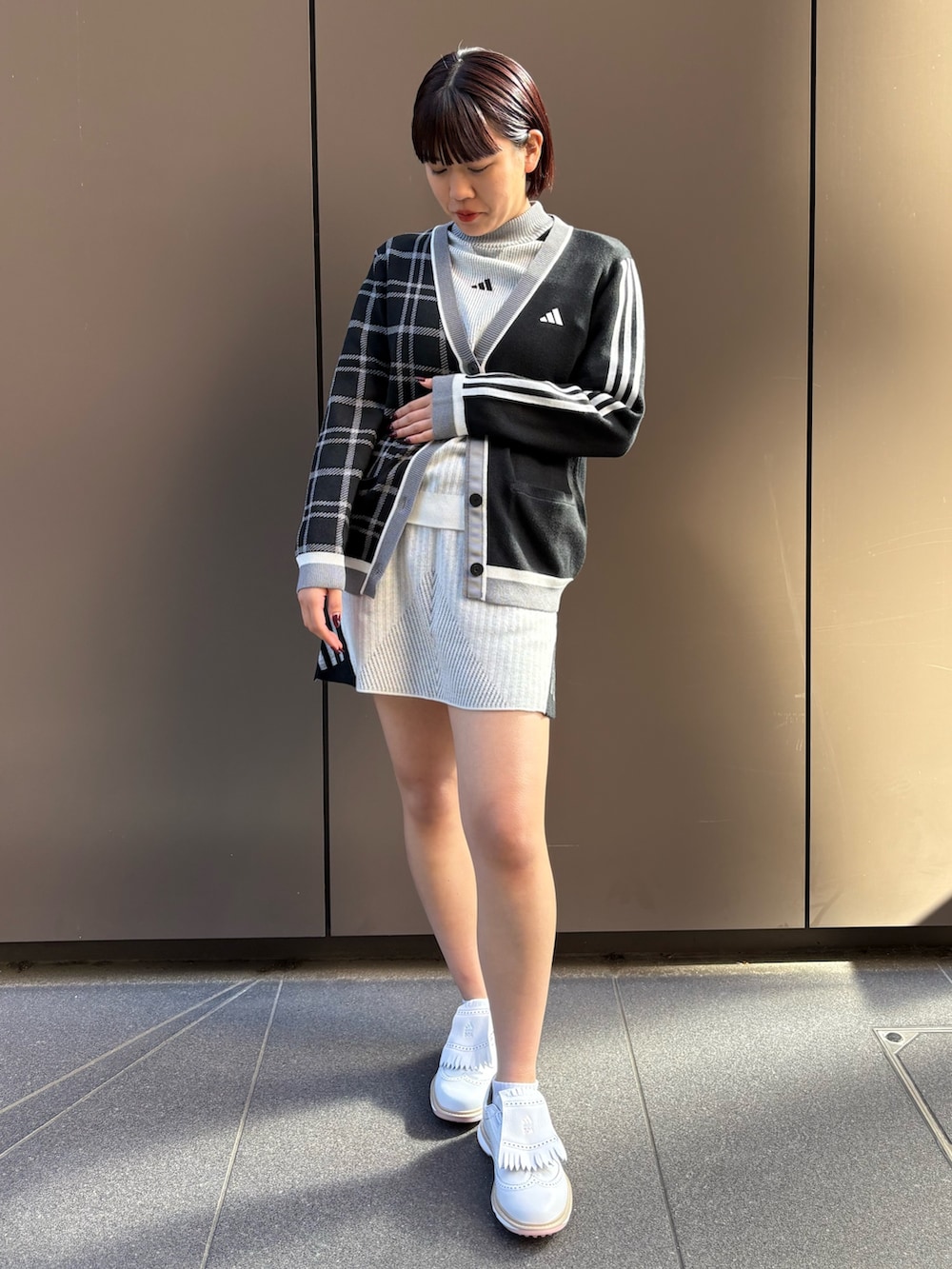 ブラック系のカーディガン/ボレロ、ホワイト系のニット/セーター、ホワイト系のスカートを着用したレディースの秋コーディネートの2枚目の写真