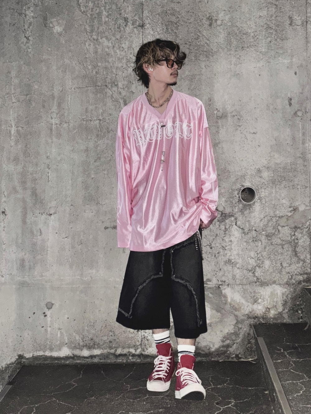 ピンク系のTシャツ/カットソー、ブラック系のデニムパンツ、レッド系のスニーカーを着用したメンズの夏コーディネートの3枚目の写真