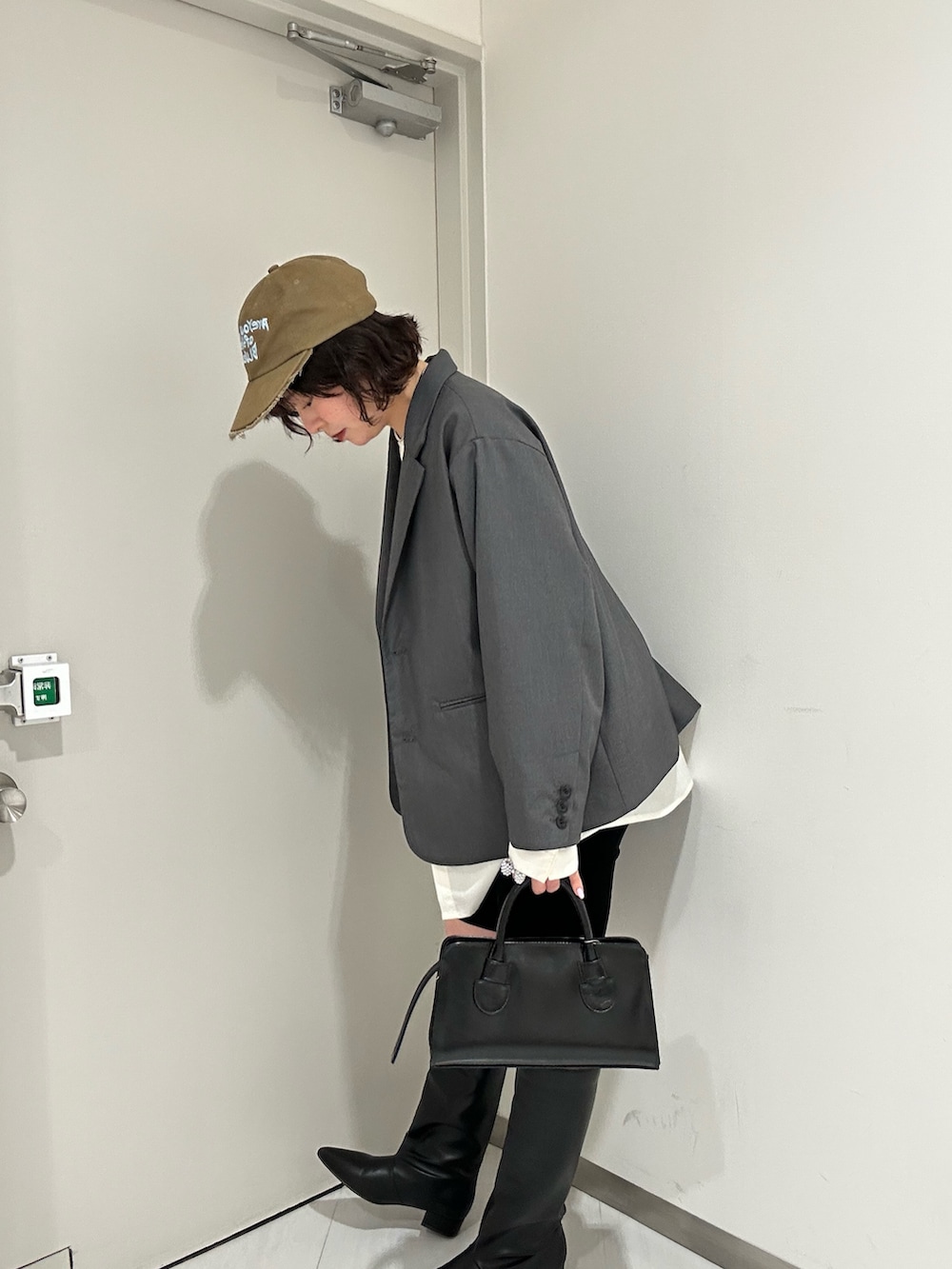 ホワイト系のTシャツ/カットソー、グレー系のその他アウター、ブラック系のその他パンツを着用したレディースの冬コーディネートの2枚目の写真