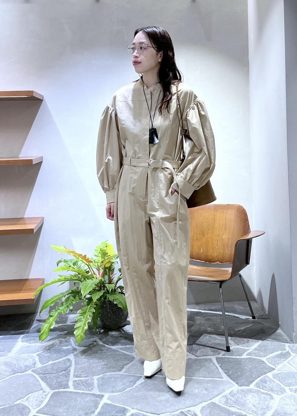 ホワイト系のパンプス、ブラウン系のショルダーバッグ、ベージュ系のつなぎ/オールインワンを着用したレディースの冬コーディネートの2枚目の写真