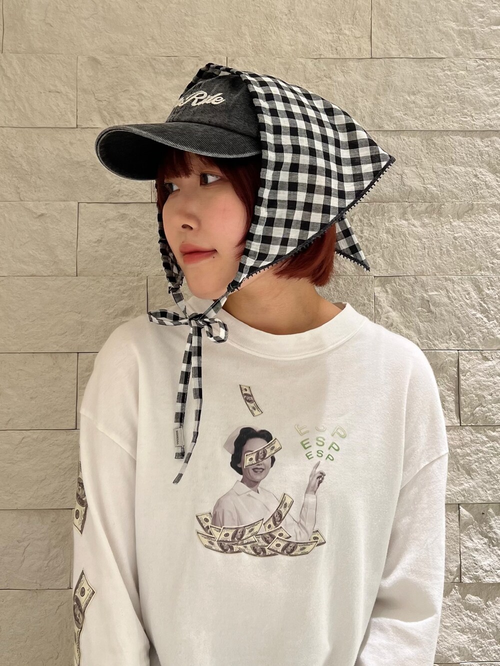 ブラック系のスニーカー、ブラック系のヘアバンド、ブラック系のキャップを着用したレディースの春コーディネートの2枚目の写真