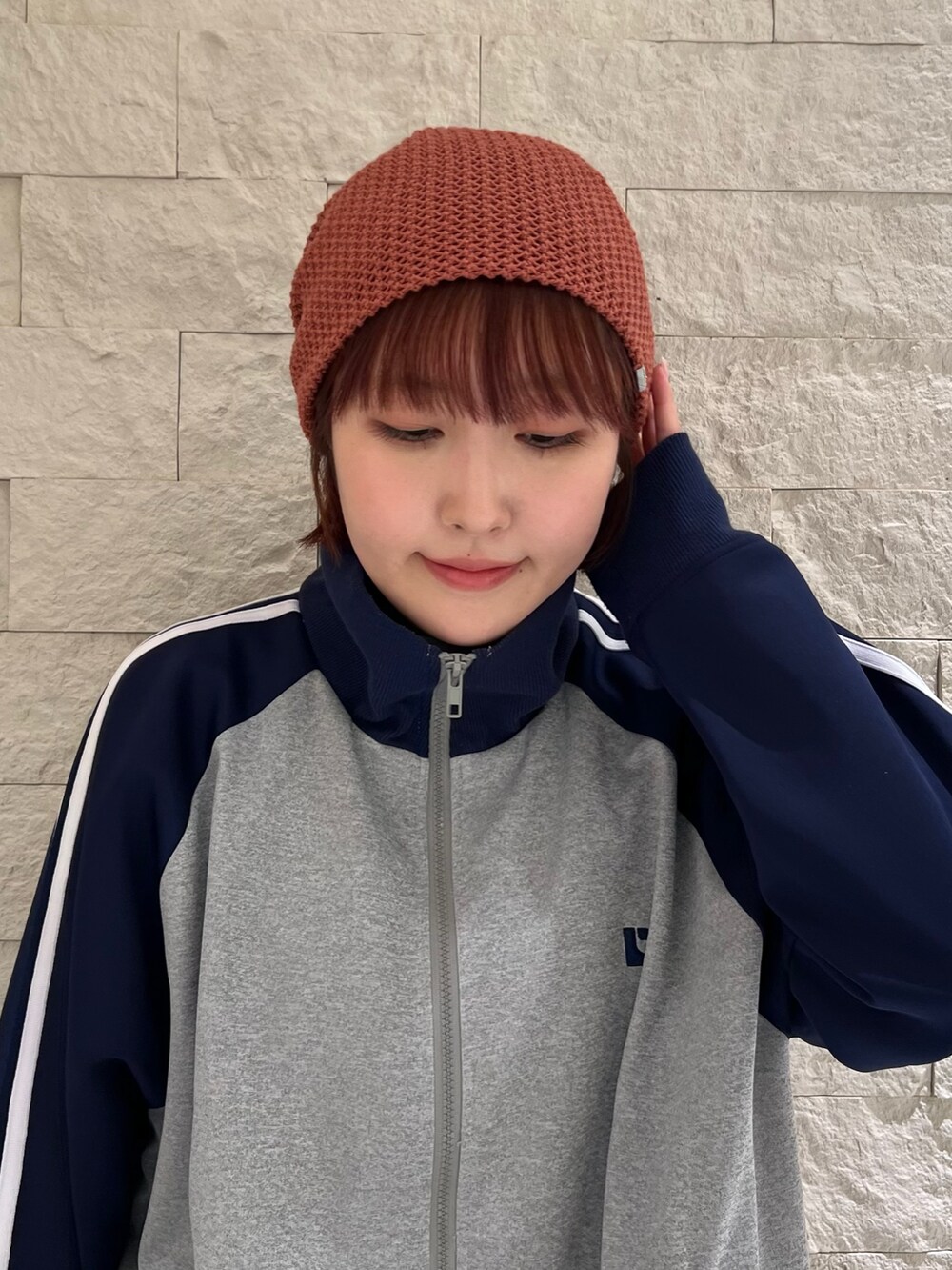 ブラック系のスニーカー、レッド系のニットキャップ/ビーニーを着用したレディースの春コーディネートの2枚目の写真