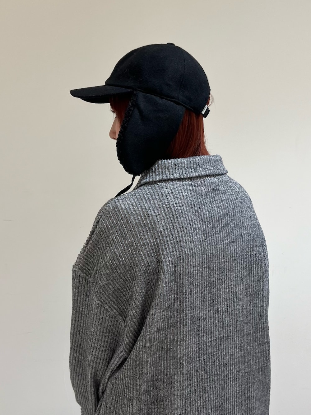 ブラック系のキャップを着用したレディースの冬コーディネートの2枚目の写真