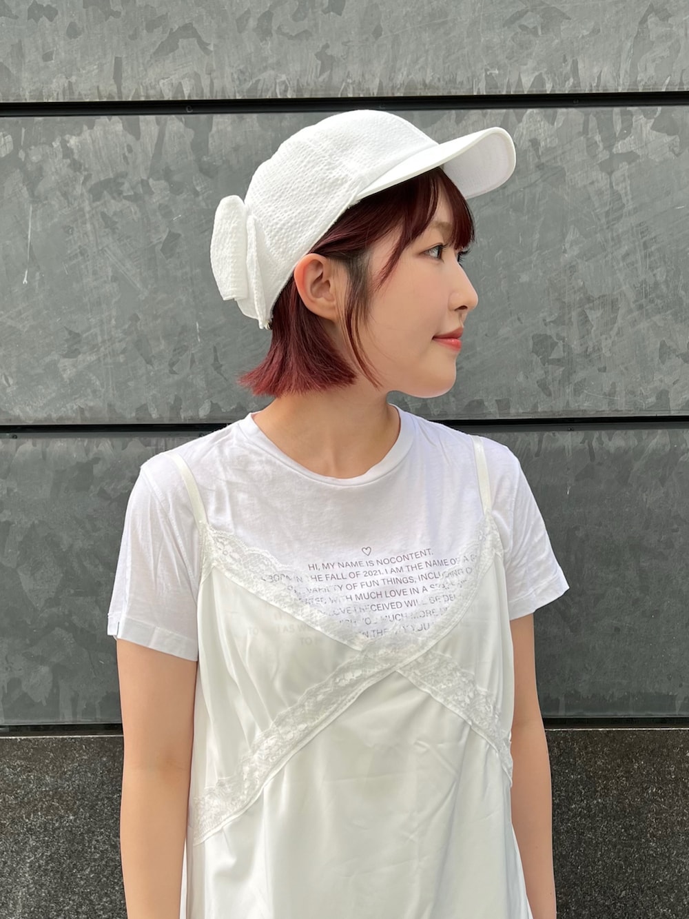 ホワイト系のキャップを着用したレディースの夏コーディネートの3枚目の写真