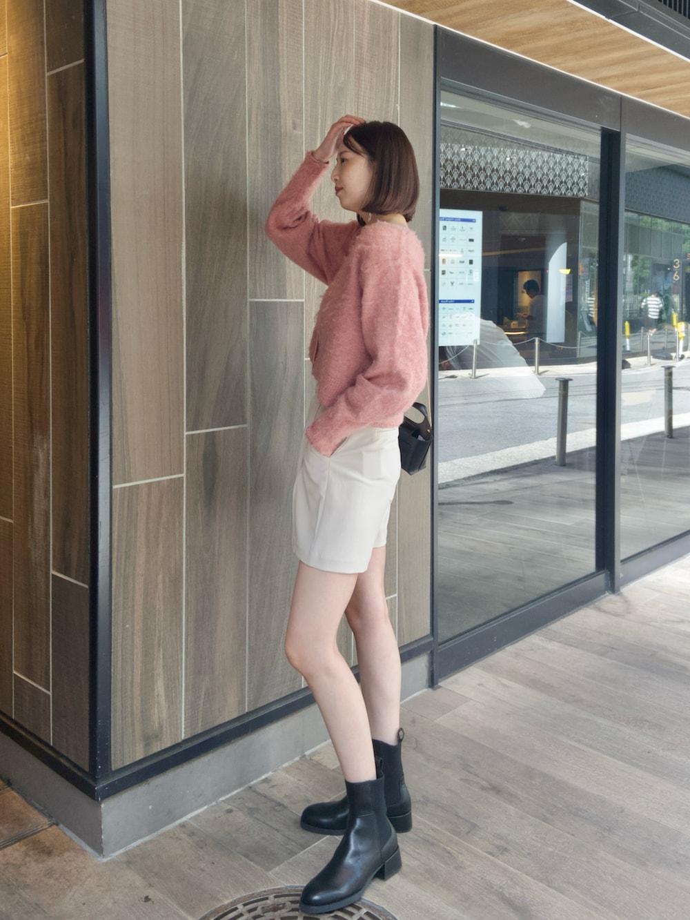 ピンク系のカーディガン/ボレロ、ホワイト系のその他パンツ、ブラック系のブーツを着用したレディースの秋コーディネートの2枚目の写真