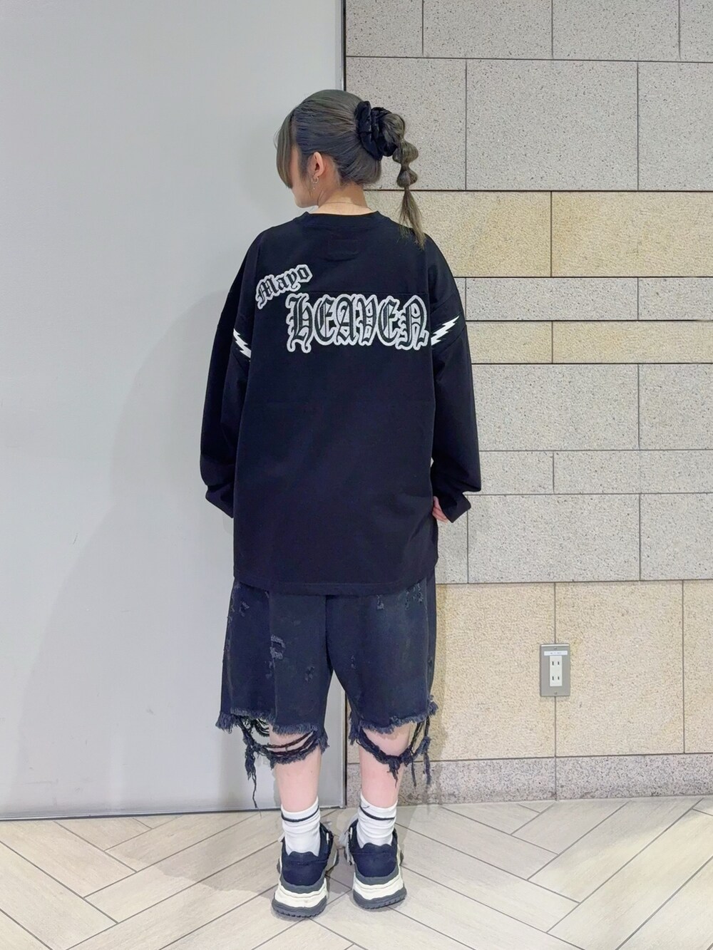 ブラック系のTシャツ/カットソー、ブラック系のデニムパンツを着用したレディースの秋コーディネートの3枚目の写真