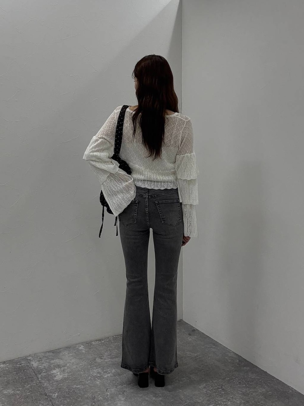 ホワイト系のキャミソール、ブラック系のサンダル、グレー系のデニムパンツを着用したレディースの夏コーディネートの5枚目の写真